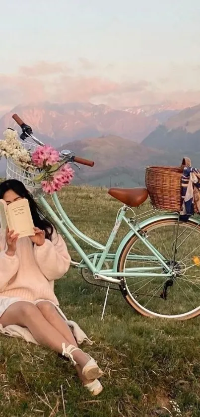 Woman reading by a vintage bicycle in scenic mountain landscape.