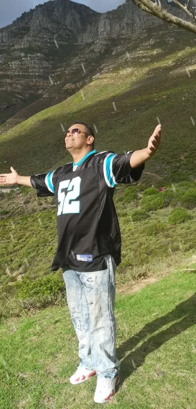 Person enjoying serene mountain views with arms wide open in nature.