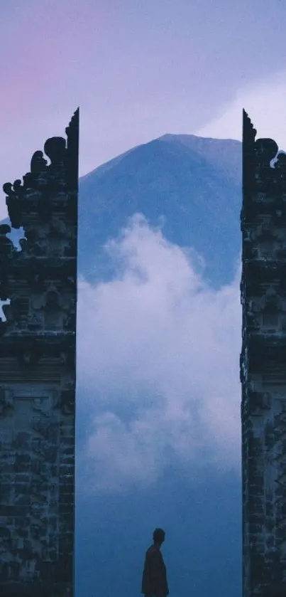 Serene gateway framing a mountain under a cloudy sky.