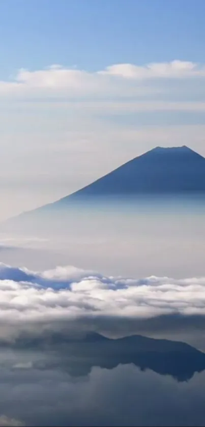 Mountain silhouette with clouds and blue sky.