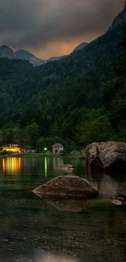 Calm mountain lake with forest and rocks at dusk.