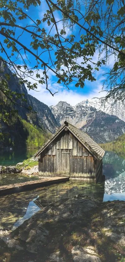 Rustic cabin by a serene mountain lake with forest backdrop.