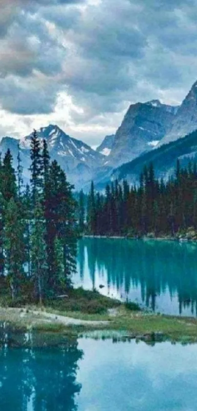 Photo of a serene mountain lake with trees and snow-capped peaks.