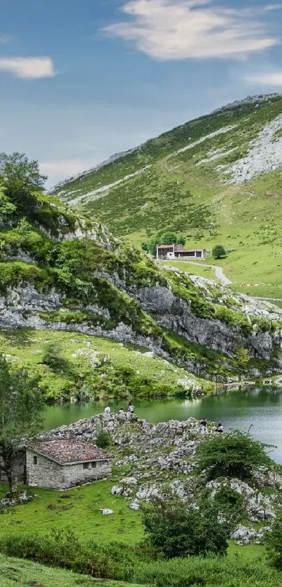 Tranquil mountain lake with green hills and a rustic cabin.