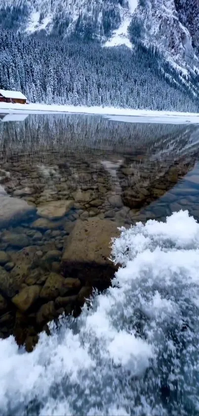 Serene mountain lake with snowy peaks and reflections in clear water.