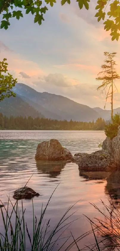 Serene sunset view over a lake with mountains and trees.