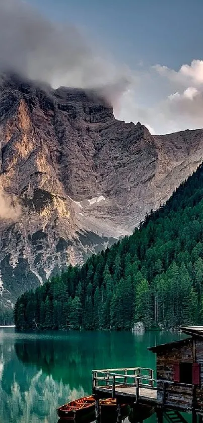 Serene lake with mountains and cabin in forest backdrop.