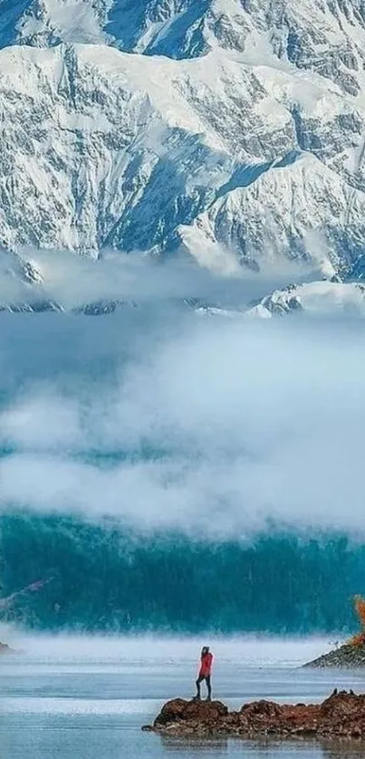 Snow-capped mountain with reflective lake and scenic view.