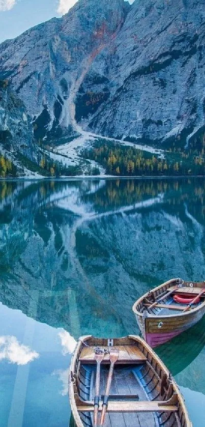 Mountain lake with wooden boats and reflections.