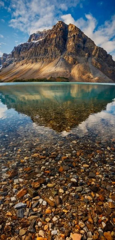 Mountain reflected in clear lake under blue sky.