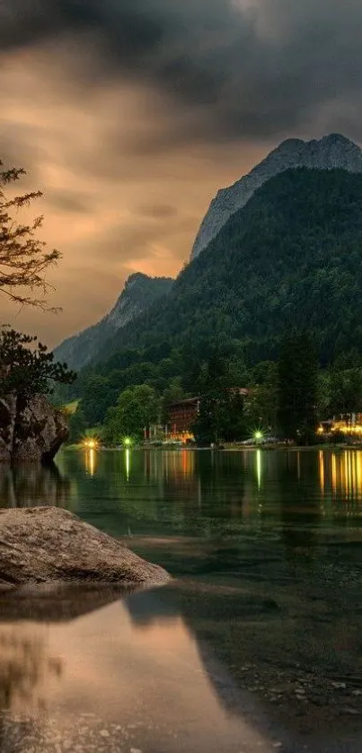 Serene lake with mountains and sunset sky.