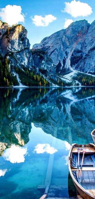 Mountain lake with boats and sky reflection.