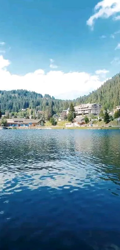 Serene mountain lake view with blue sky and forested hills.