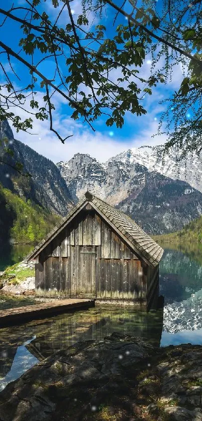 Tranquil mountain lake with a rustic cabin.