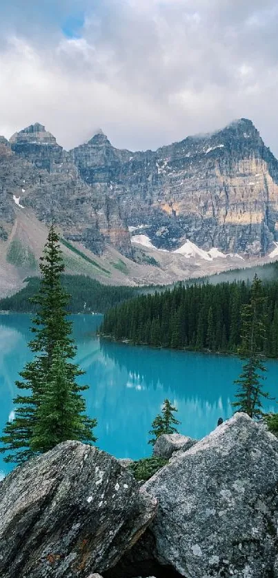 Serene mountain lake with pine trees and turquoise water.