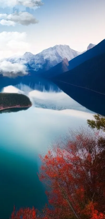 Serene mountain lake with reflections and vibrant foliage.