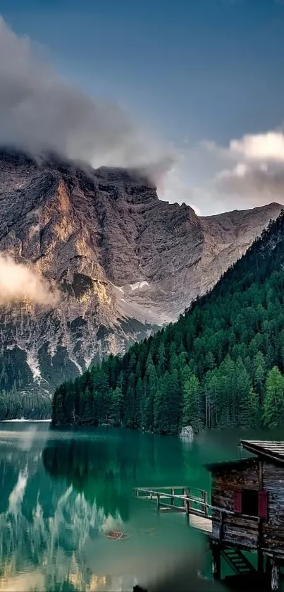 Mountain lake with forest and clouds reflecting.