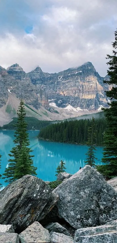 Scenic view of turquoise lake and mountain landscape with trees.