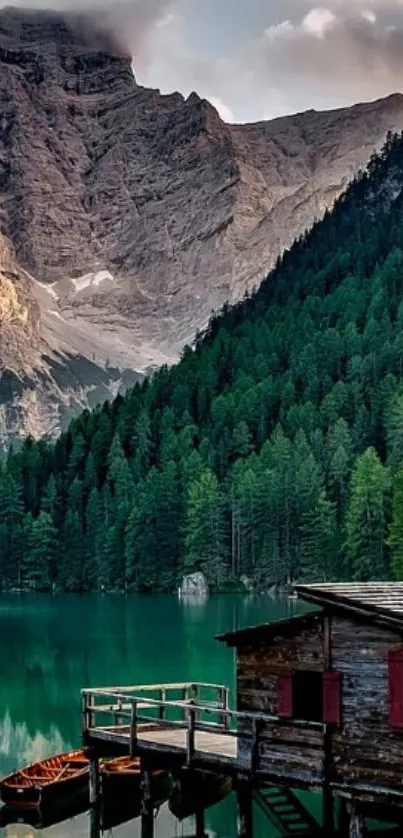 Serene mountain lake with forest and wooden cabin.