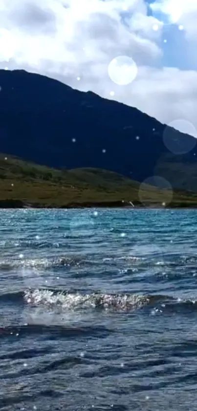 Serene mountain lake with sparkling waters under a clear sky.