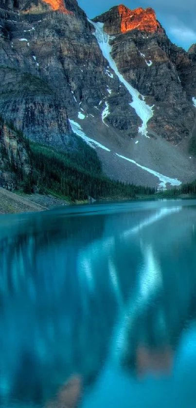 Serene mountain lake with blue waters and rocky peaks.