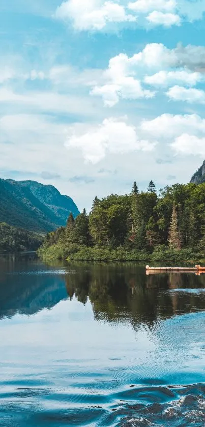 Serene lake with mountains and forest reflecting in the clear blue water.