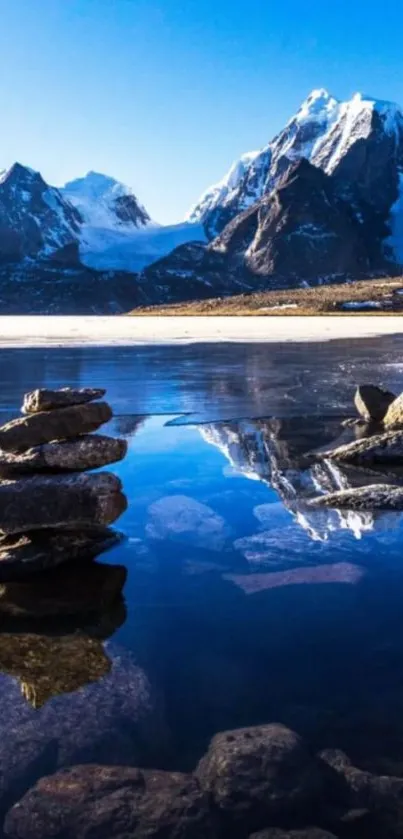 Serene mountain lake with reflections and snowy peaks.