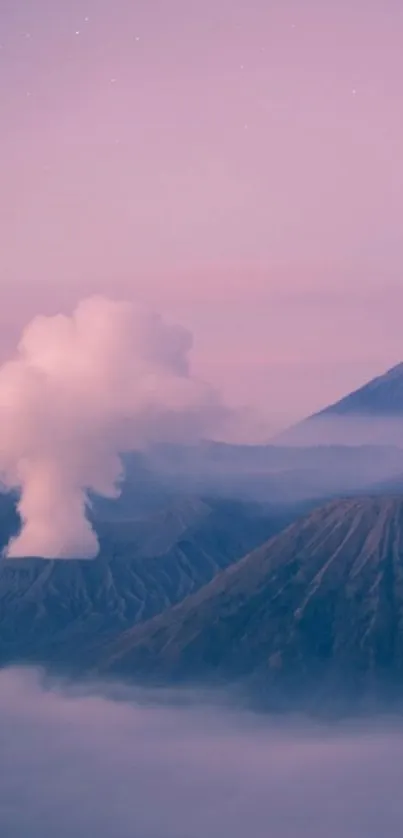 Serene sunrise over Mount Bromo with mist and pink sky.