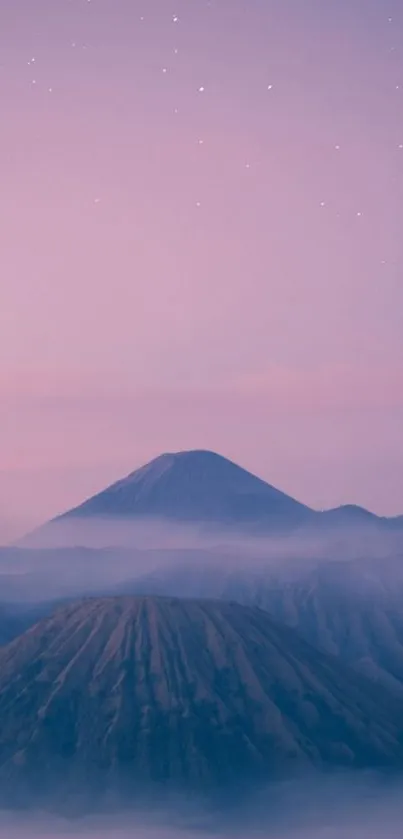 Serene mountain landscape at dawn with misty atmosphere and pastel sky.