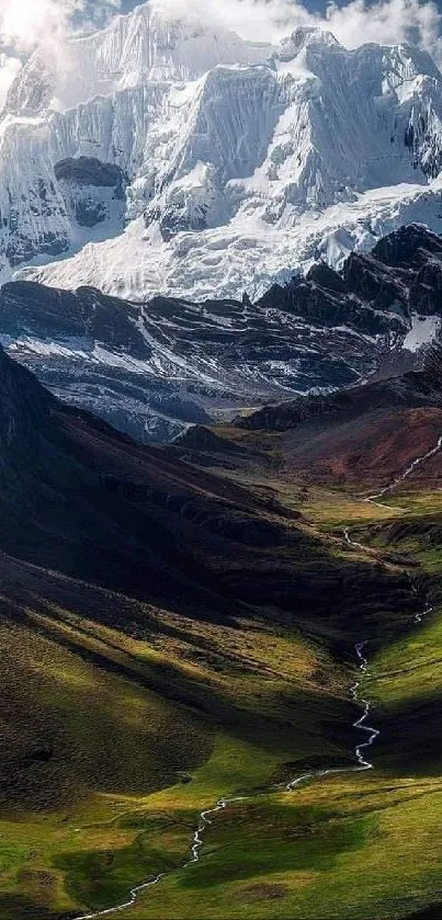 Majestic snow-capped mountain with lush green valley.