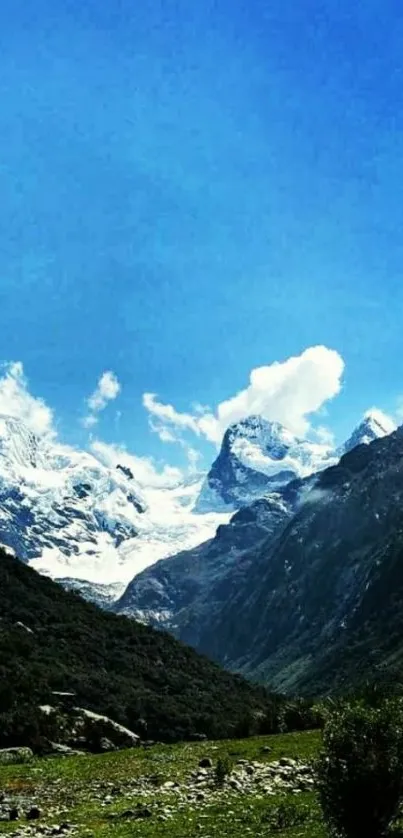 Beautiful mountain landscape with blue sky and snow-capped peaks.