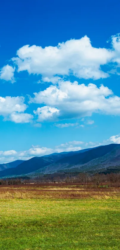 Serene mountain landscape with blue skies and green fields.