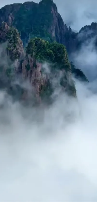 Misty mountains with lush greenery and clouds.