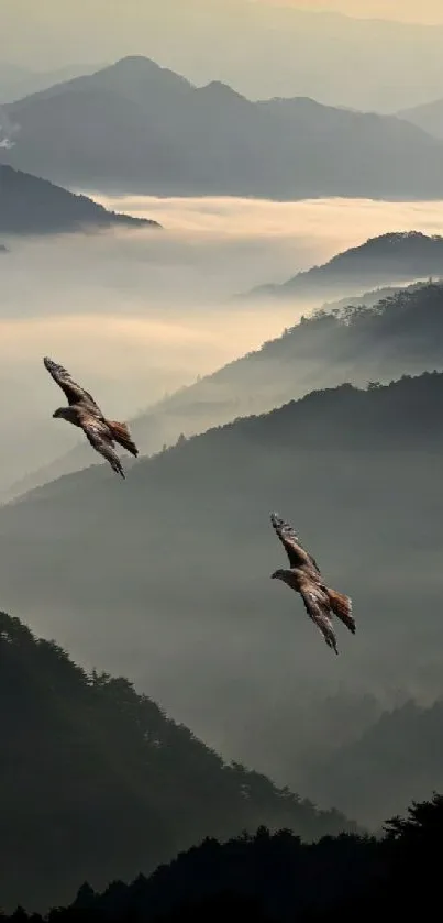 Serene misty mountain landscape with two birds in flight.