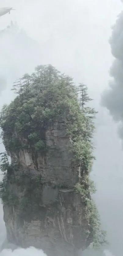 Misty mountain summit surrounded by clouds and a distant airship.