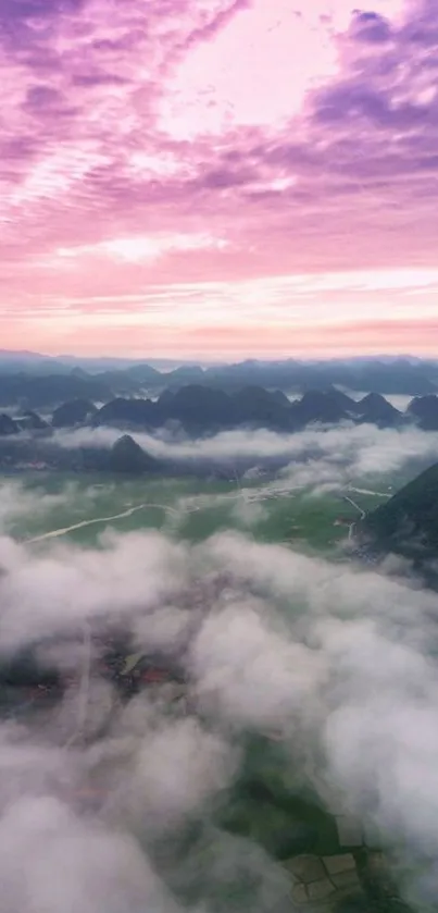 Misty mountain landscape with pink sky and lush greenery.