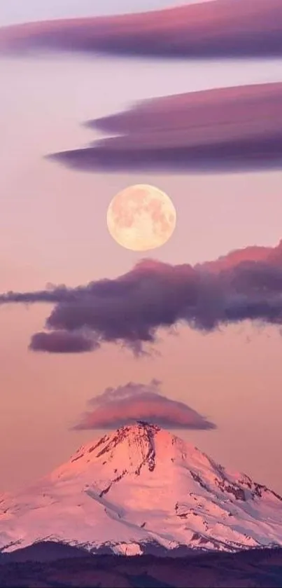 Snowy mountain under a full moon with pink clouds at dusk.