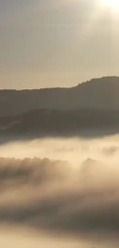 Mist over mountains with sun rays creating a serene atmosphere.