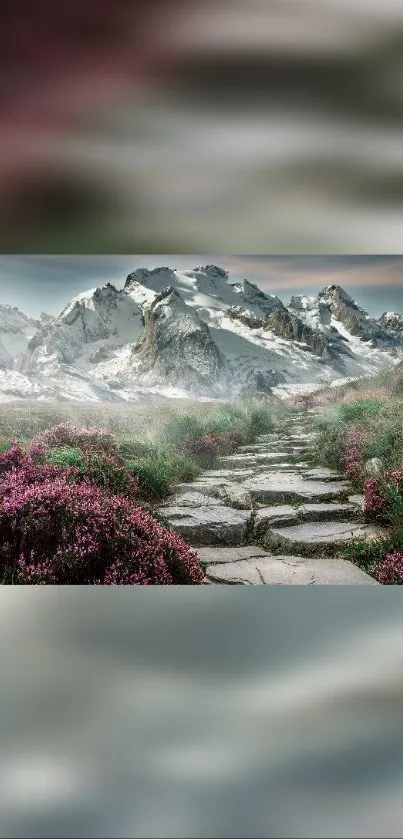 Scenic mountain path with wildflowers under a snowy peak.