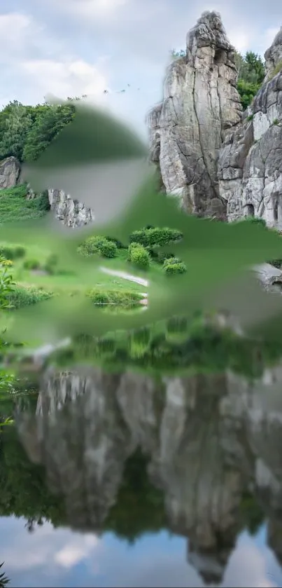 Serene mountains reflected in calm water with lush greenery.