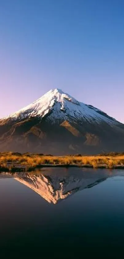 Beautiful mountain reflected in calm lake under a vibrant sky.