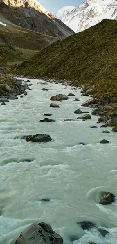 A serene mountain river flows through a lush green valley with snow-capped peaks.