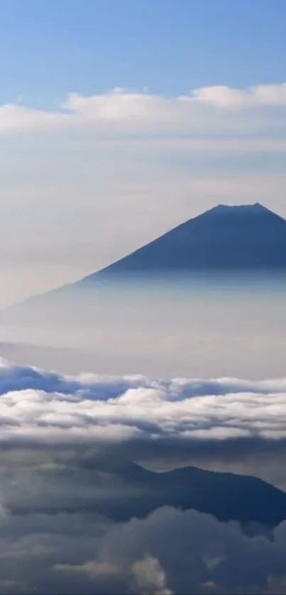 Mountain and sky wallpaper with misty clouds.