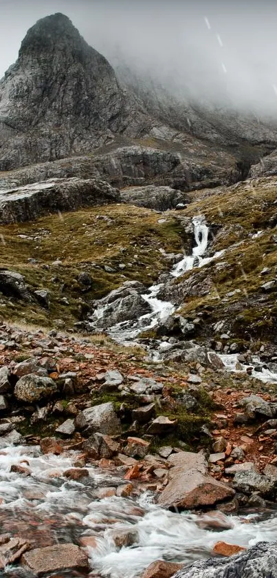 Calming mountain stream under misty hills.