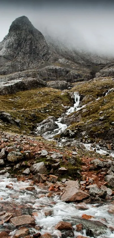 Misty mountain landscape with serene stream.