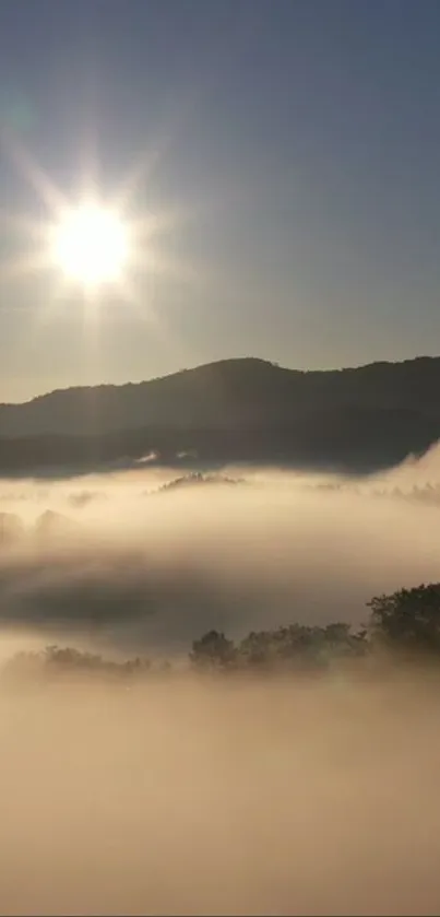 Sunrise over foggy mountains with shining light and mist.