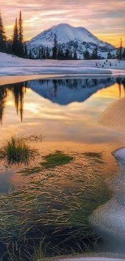 Serene sunset reflecting in snow-capped mountains and calm lake.