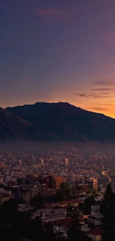 Cityscape with mountains and sunset, showcasing purple and orange sky.