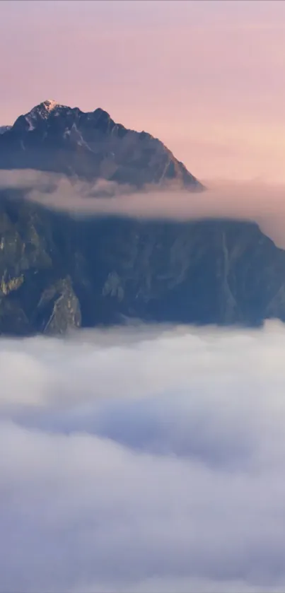 Mountain peaks at sunset with pink and purple sky.