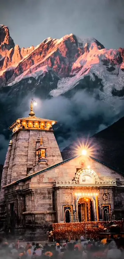 Illuminated mountain temple with misty backdrop.